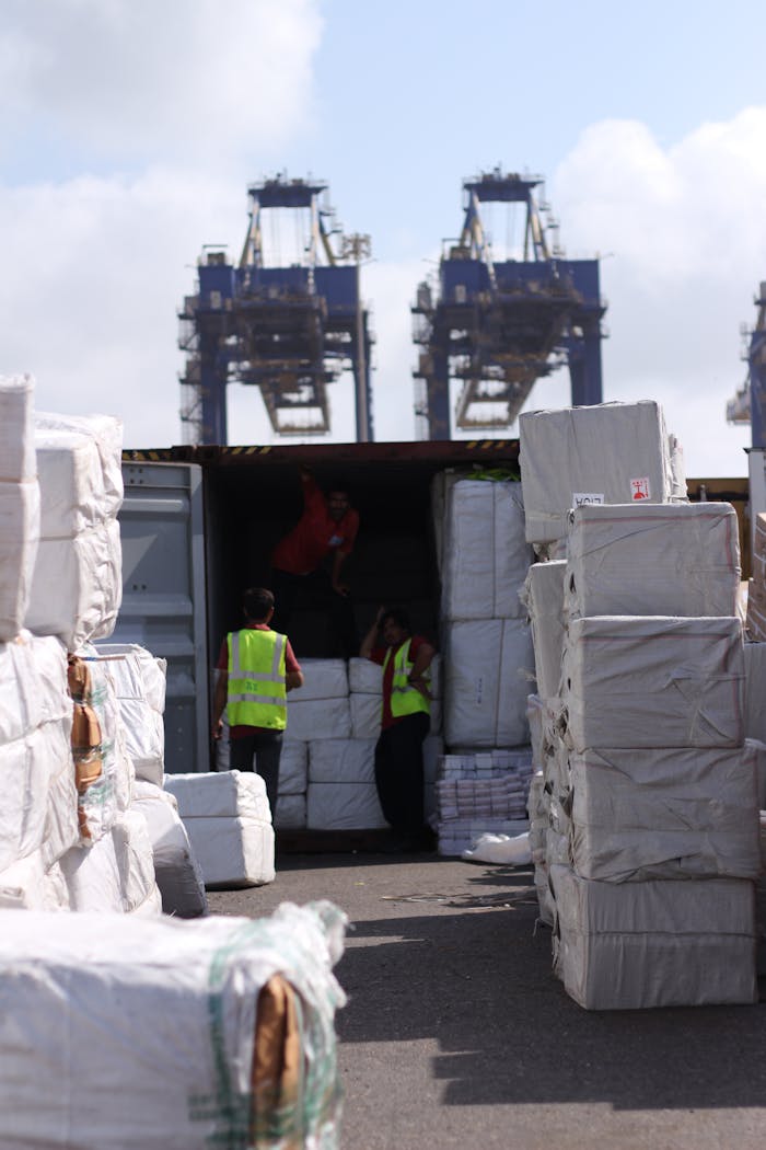 gallery-2 Dock workers loading cargo at Karachi Port with visible cranes and containers.